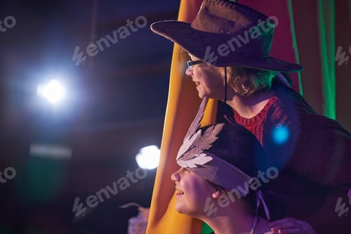 Preview: Two Excited Girls Waiting behind Curtains during Play at Childrens Theater