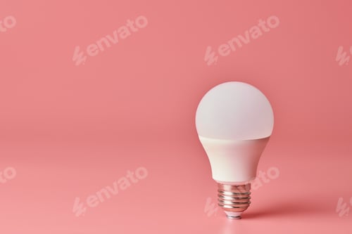 Preview: Energy saving light bulb, copy space, pink background. Minimal idea concept.