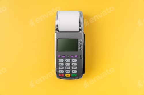 Preview: Card reader machine with invoice bill on yellow background. Online payment concept.