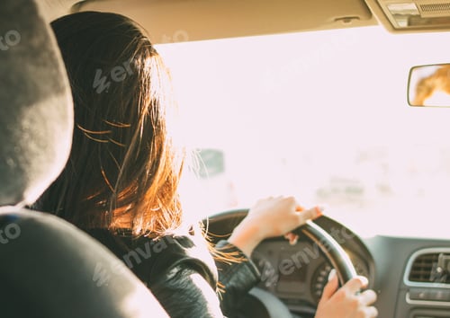Preview: Young brunette long hair woman driving passenger car