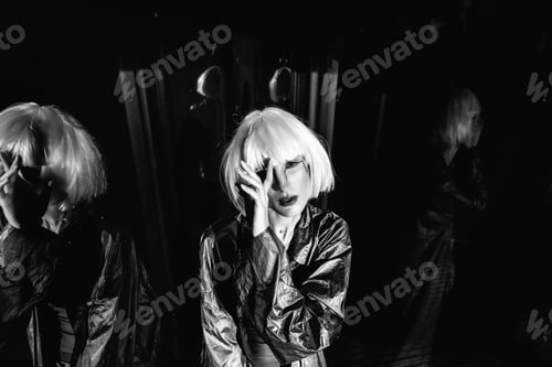 Preview: Fashion of the future. Futuristic blonde in black space.