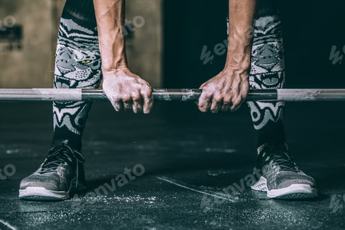 Preview: woman legs and hands holding and lifting a bar weights training working out in Gym