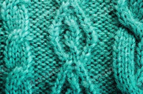Preview: Knitted texture. Pattern fabric made of wool. Turquoise background, copy space