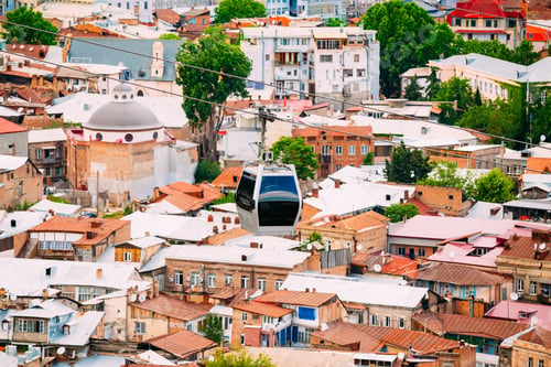 Preview: Modern New Cableway Ropeway Tinted Car Moving Under Old Resident