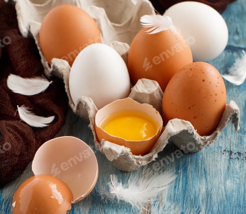 Preview: Сhicken eggs in a box on a blue wooden background