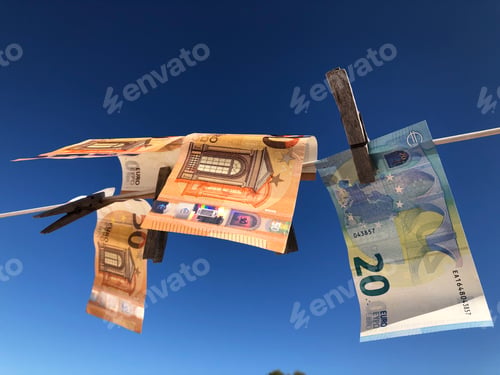 Preview: Euro banknotes pegged to a clothesline drying in the sun. Money laundering concept