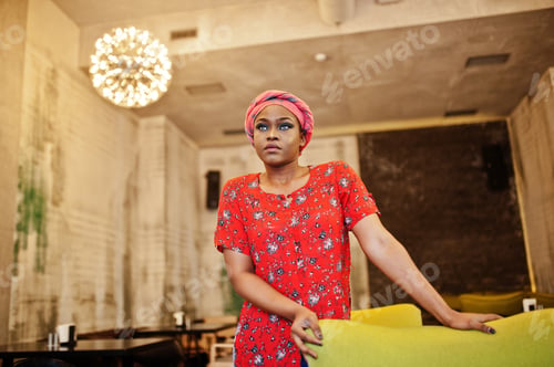 Preview: Stylish african woman in red shirt and hat