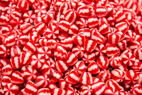 Preview: Bright red and white gummies, top view.