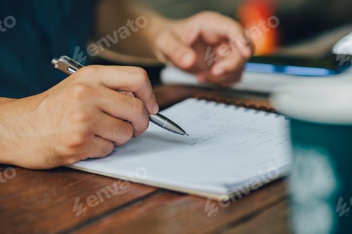 Preview: Man writing in a notebook. Write down important business data information creative start up ideas