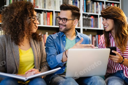 Preview: Group of happy students reading books and preparing to exam in library