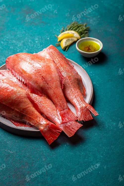 Preview: Fresh red sea bass on blue background.