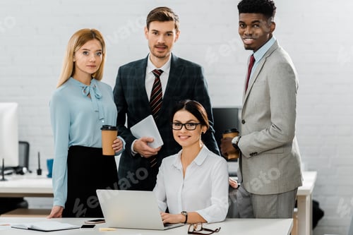 Preview: portrait of multiethnic business colleagues in formal wear at workplace in office