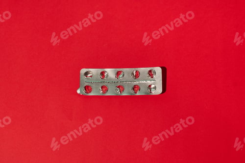 Preview: Empty pills package on a red background