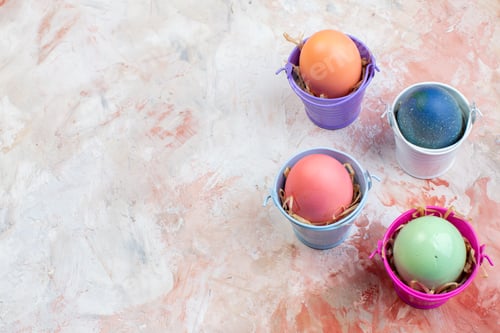 Preview: front view colored easter eggs inside separate little baskets on a light background ornate spring