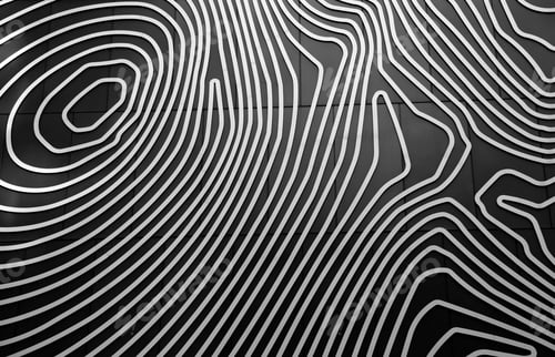 Preview: Closeup of an abstract patterned design on a black background of a building shot in grayscale