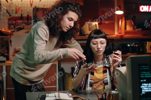Preview: Colleagues repairing computer detail in team