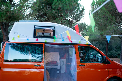 Preview: Camper van in the field with chairs and table for recreation. van life concept .