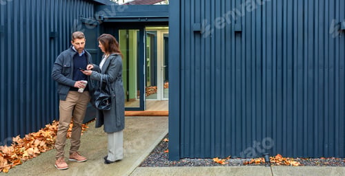Preview: Couple discussing modular home made with shipping containers real estate options using smartphone