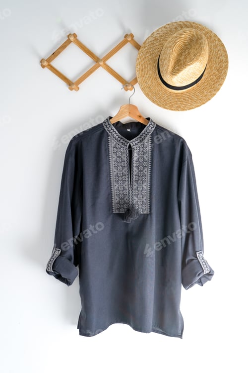 Preview: Ukrainian clothes embroidered man shirt. Blue gray and black threads background. Vyshyvanka is a