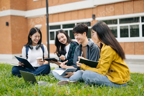 Preview: Young Asian college students and a female student group work at the campus park
