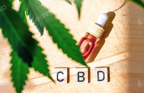 Preview: Flat lay bottle with Cannabis CBD oil letter blocks with Medical Marijuana plant leafs