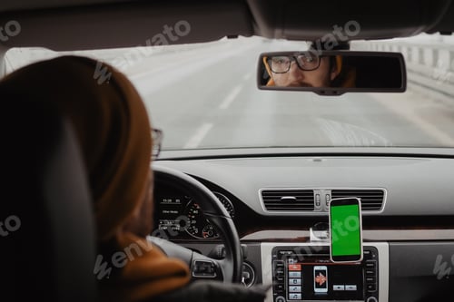 Preview: Millennial man drive the car and using mobile app , green screen