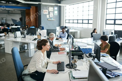 Preview: Shot of colleagues working on their computers while sitting in an office