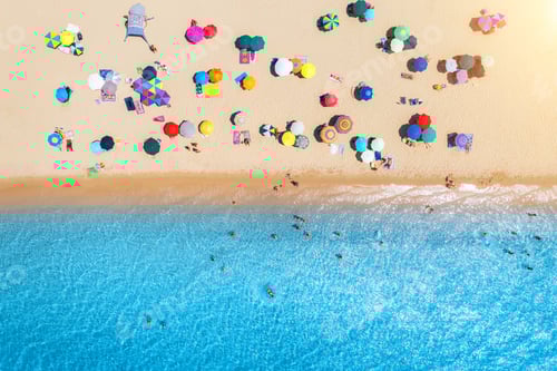 Preview: Aerial view of umbrellas on white sandy beach, blue sea at sunset