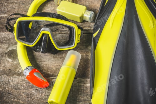 Preview: Bright snorkeling gear laid out on a wooden surface ready for an underwater adventure