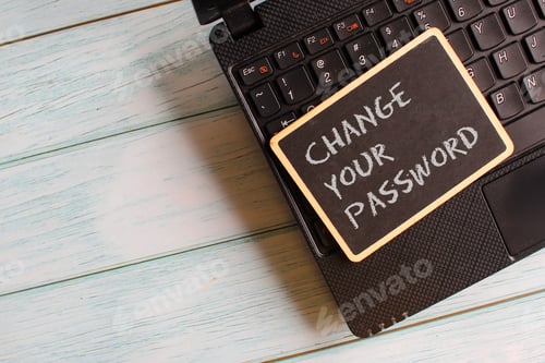 Preview: Mini blackboard with text CHANGE YOUR PASSWORD on laptop.