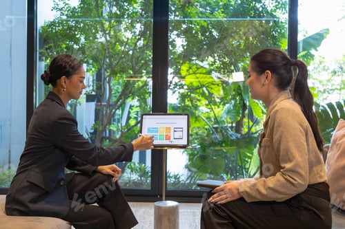Preview: Business friends working together in the common area of the condo.