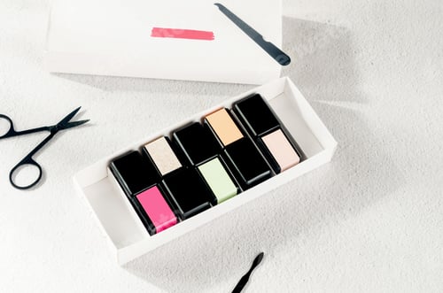 Preview: Still life with manicure equipment and multi-colored bottles with nail polish