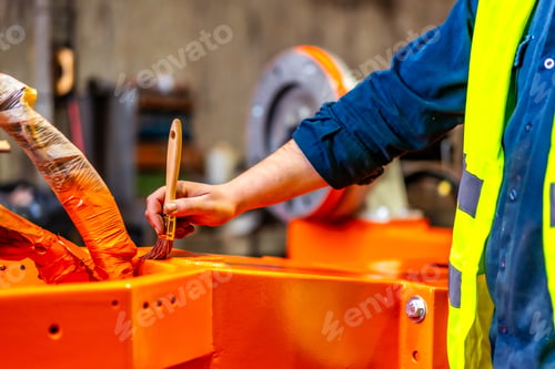 Preview: A worker painting a part of a robotic arm