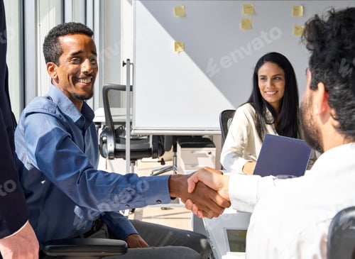 Preview: Diverse happy business men handshaking at team group meeting.