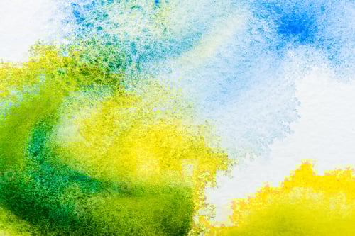 Preview: top view of blue, yellow and green watercolor spills on white paper