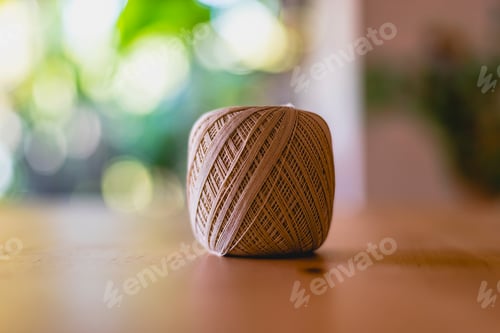 Preview: Roll of cotton yarn on a table.