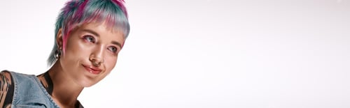 Preview: Young woman with vibrant dyed hair showcases modern youth culture in studio setting