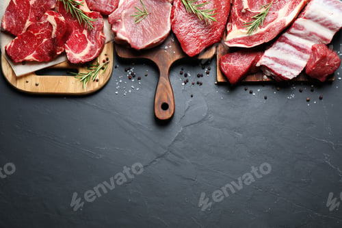 Preview: Flat lay composition with fresh meat on grey table. Space for text