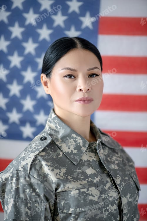 Preview: Serious mature beautiful servicewoman wearing camouflage uniform