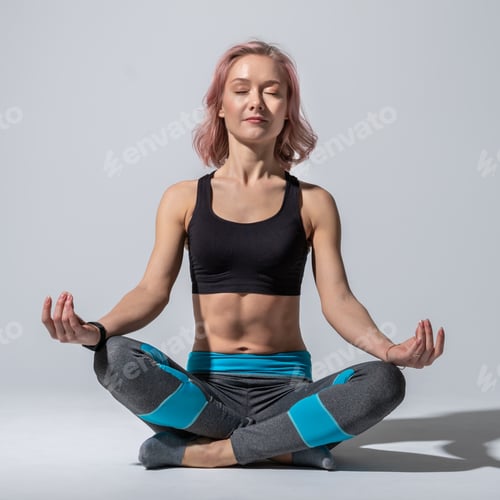 Preview: A girl in a lotus position meditates on a gray studio background