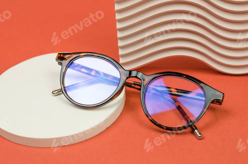 Preview: Stylish glasses on a podium made of natural stone. Leopard glasses on a colored background.
