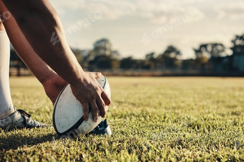 Preview: Cropped shot of an unrecognizable rugby player preparing for a kick on the field during the day