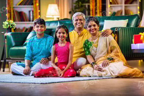Preview: Indian family siutting with gift box on sofa on diwali festival night