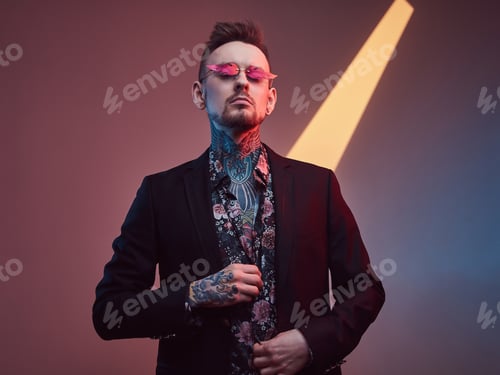 Preview: Caucasian macho in black suit with shirt in dark and colourful room