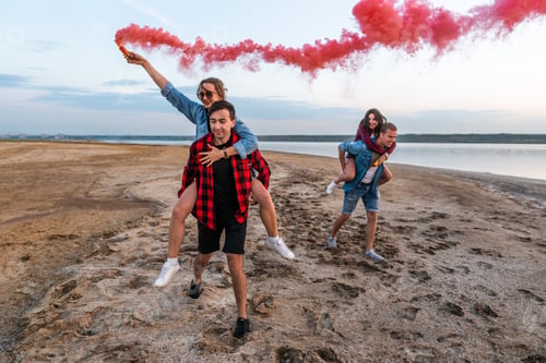 Preview: young friends running with hand flare or fusee