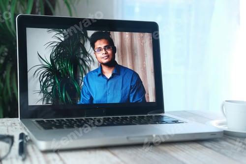Preview: Businessman In a video conference display on laptop screen