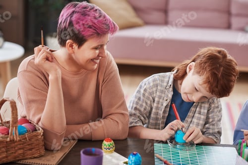 Preview: Mother painting eggs with child