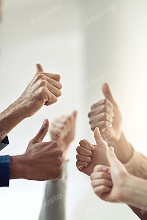 Preview: Victory achieved. Closeup shot of a group of businesspeople giving thumbs up together.