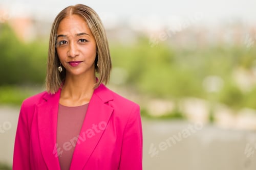 Preview: south African businesswoman CEO Headshot in blurry background. Millennial woman entrepreneur