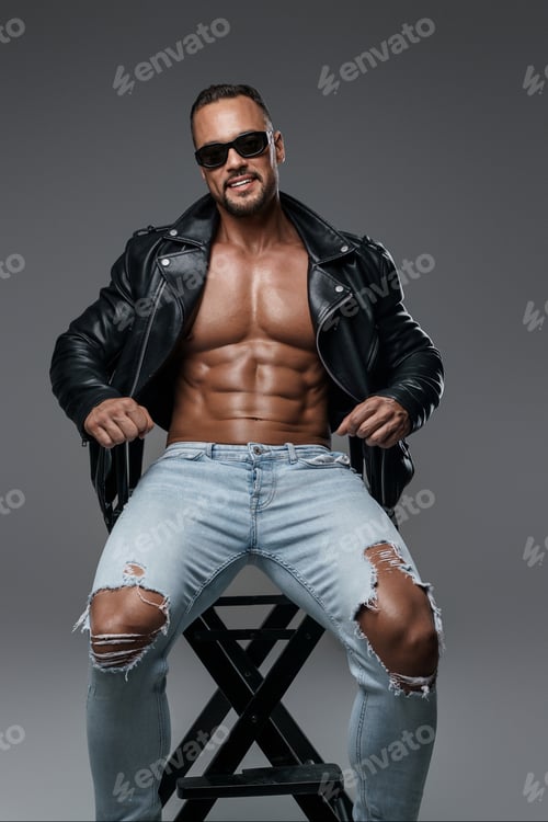 Preview: Handsome male model with muscular shirtless torso flashes a wide smile